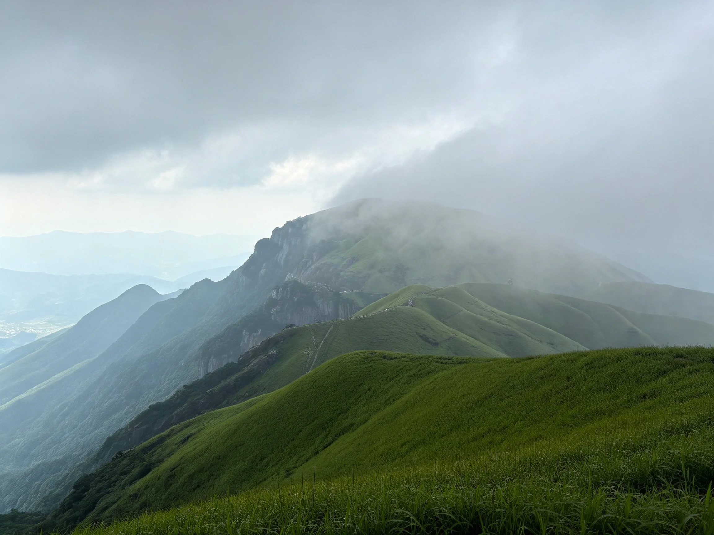 Misty Cloud-Covered Mountain Peaks with Verdant Slopes