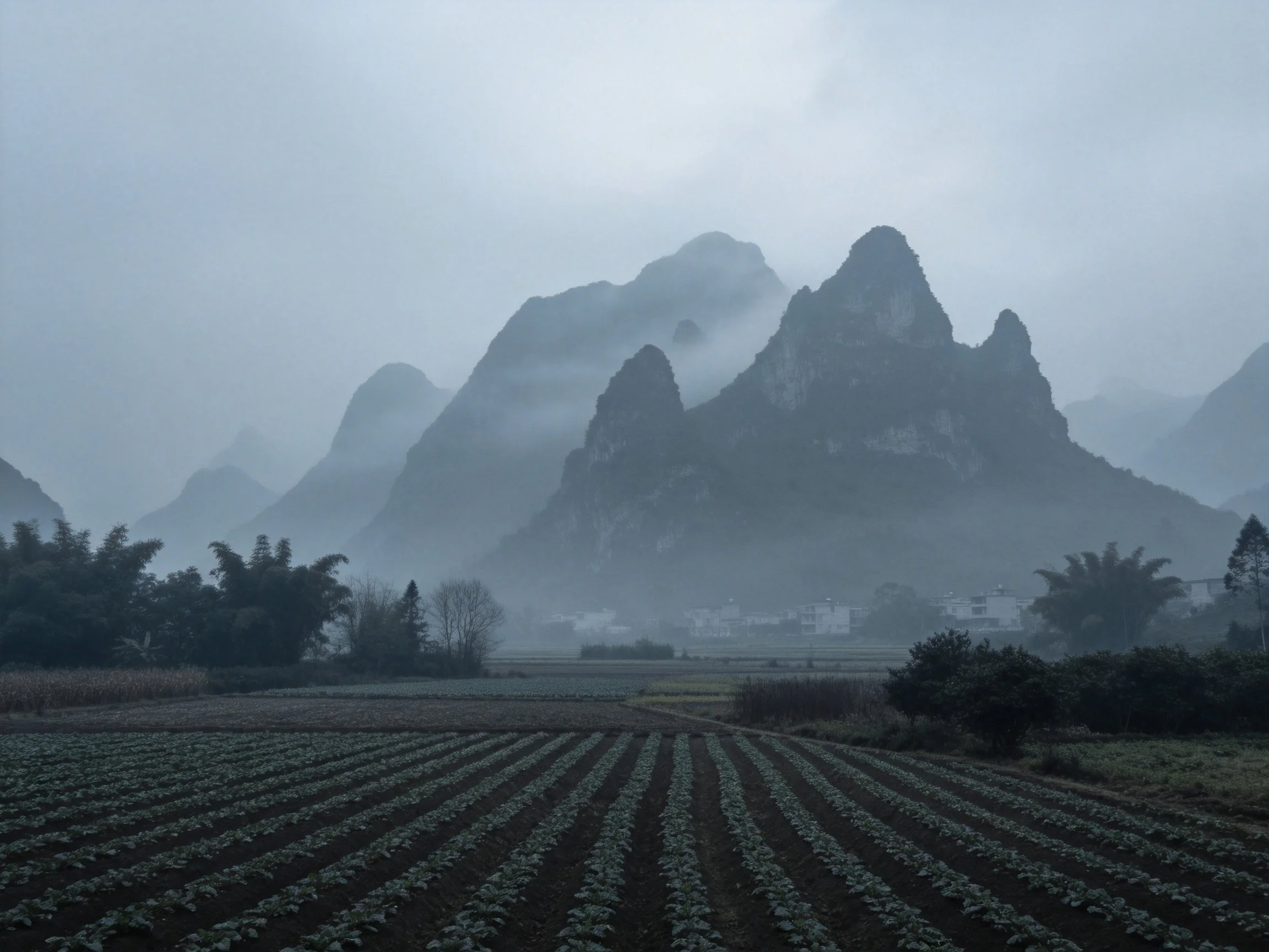 Misty Karst Mountains Over Agricultural Fields