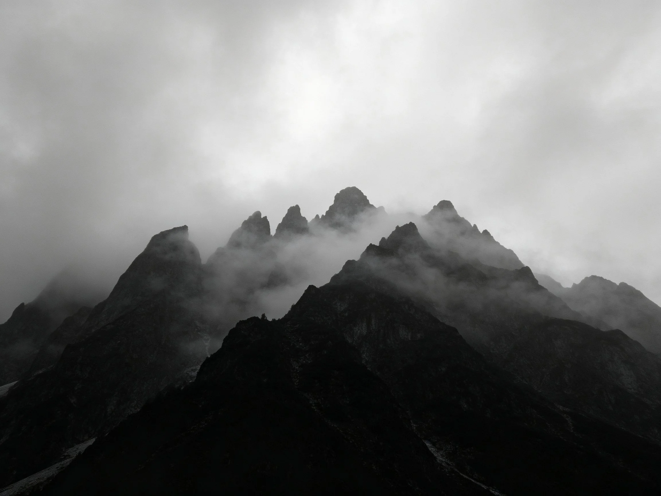 Misty Mountain Peaks Shrouded in Thick Gray Fog