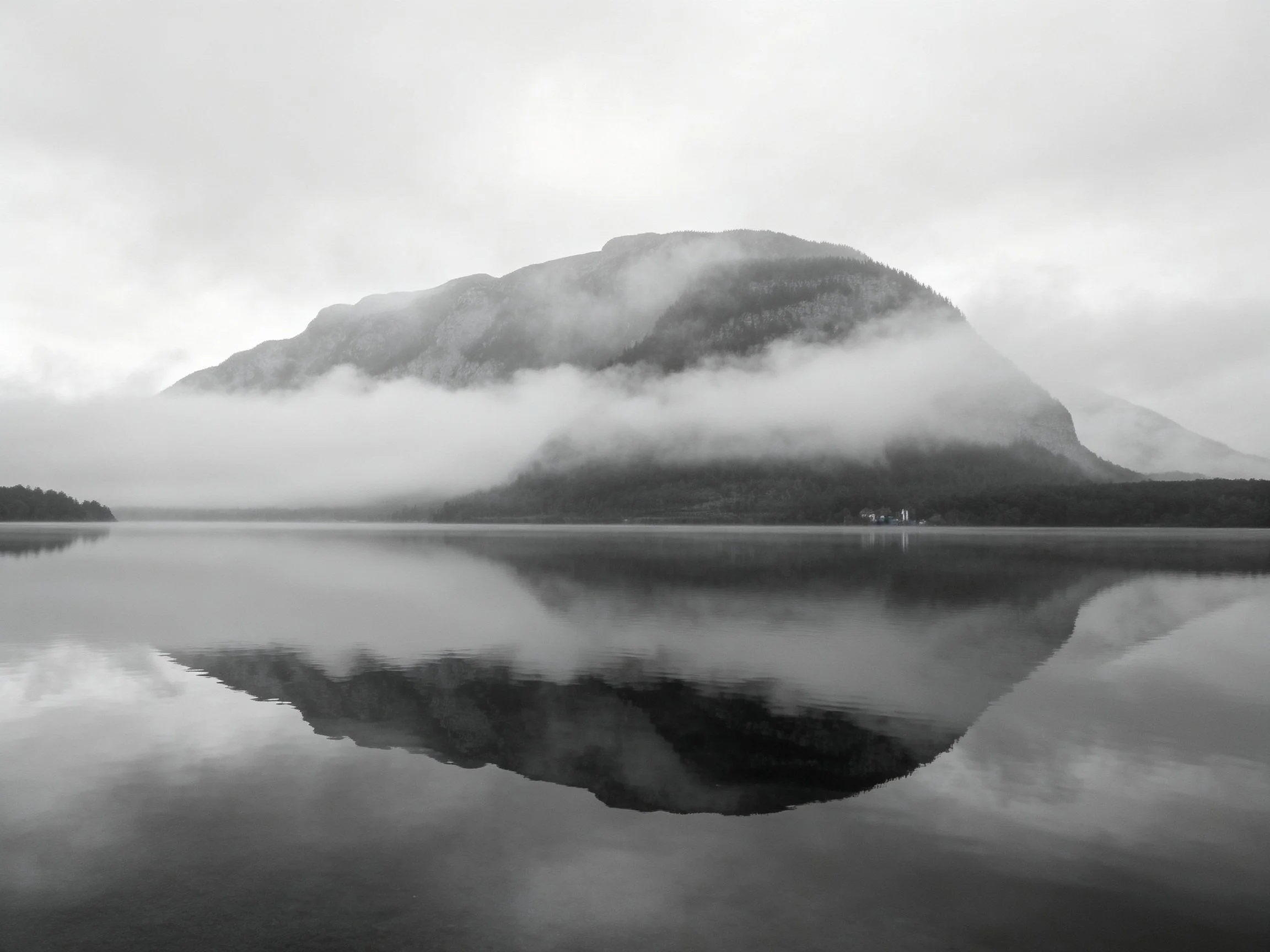Misty Mountain with Fog Reflection in Calm Black-and-White Landscape