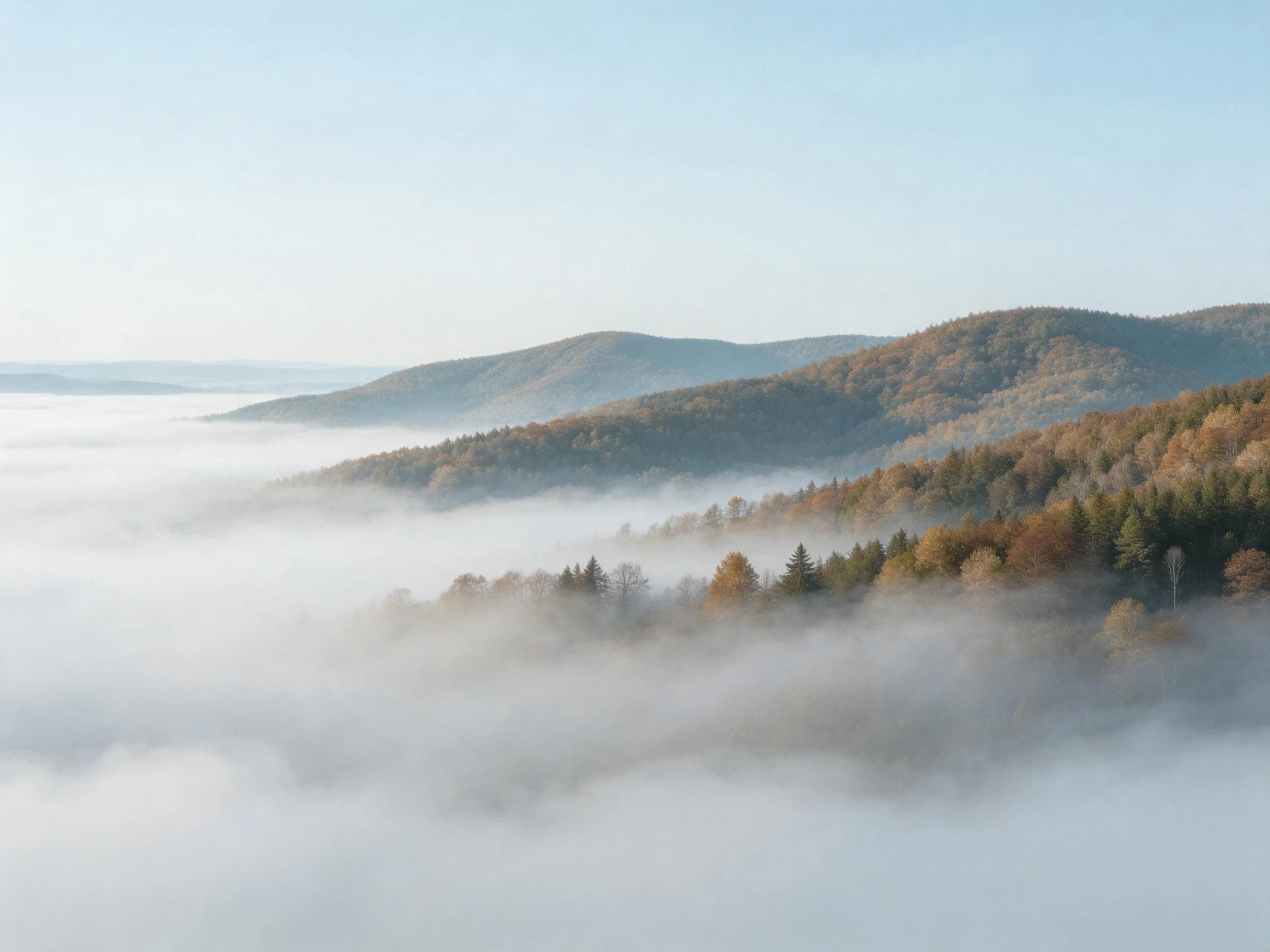 Misty mountain slopes with autumn forests and rolling hills