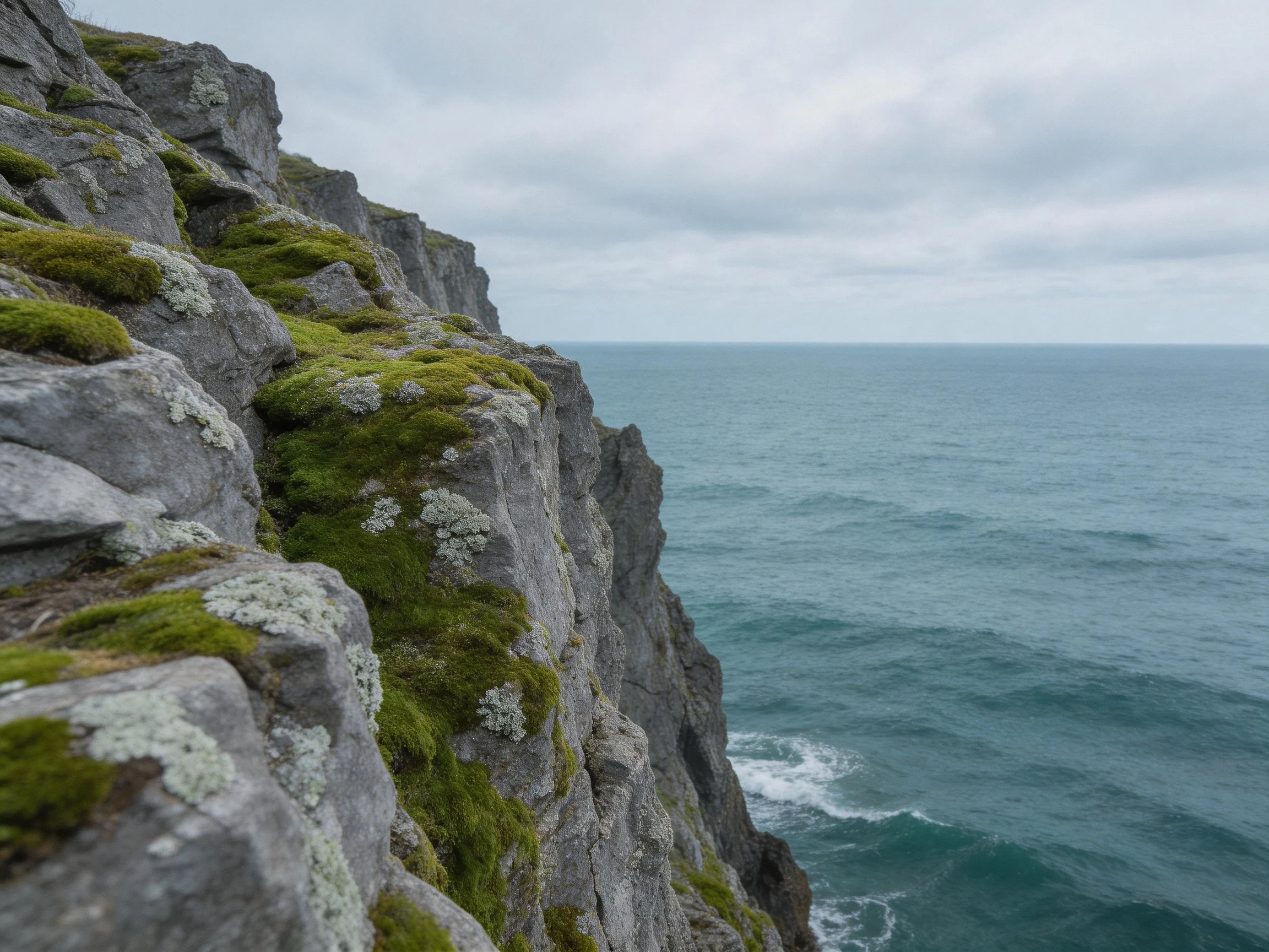 Moss-Covered Coastal Cliffs Overlooking Turquoise Ocean