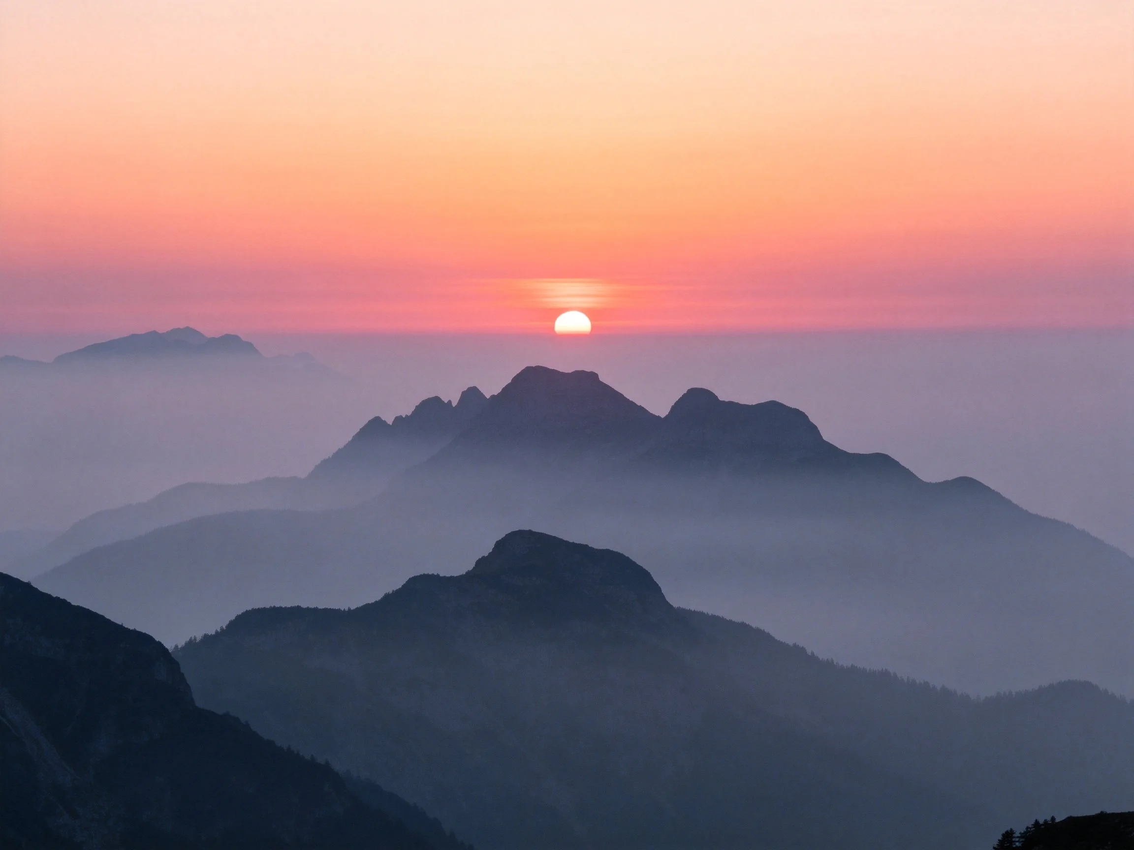 Mountain Range Sunset with Layered Foggy Peaks