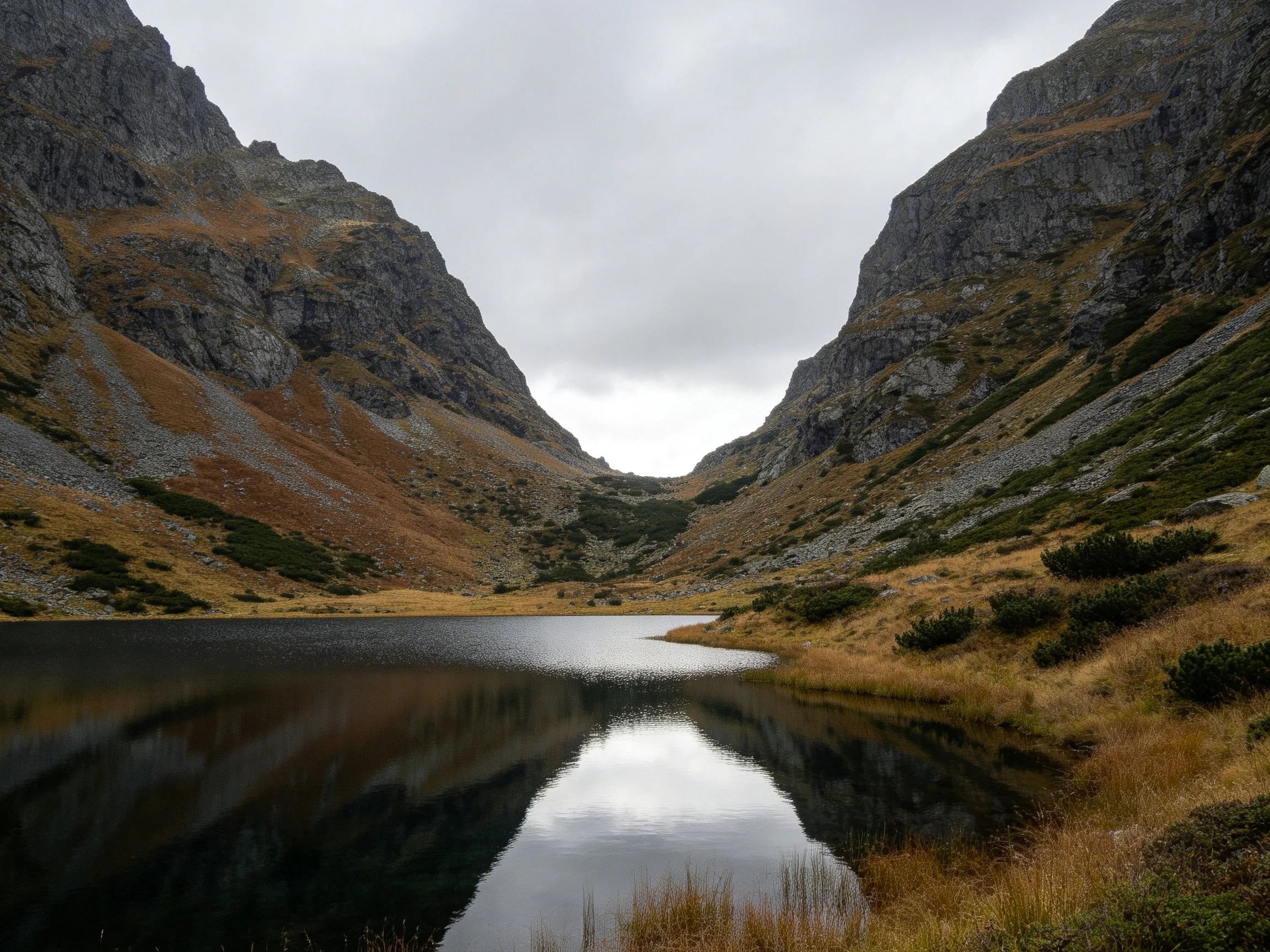 Mountain Valley Lake Reflecting Steep Rock Faces