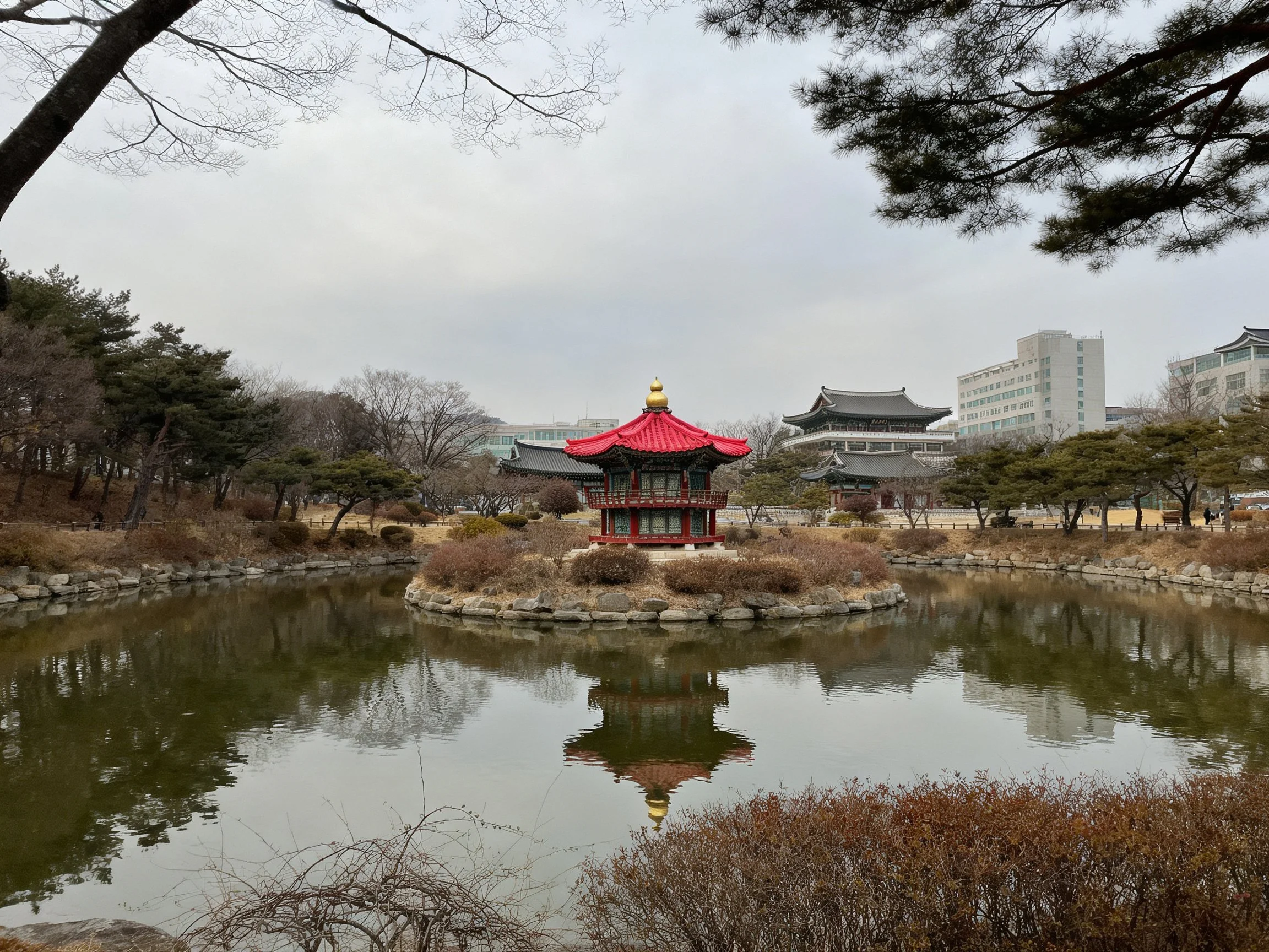 Red-roofed pavilion on pond island near traditional and modern buildings