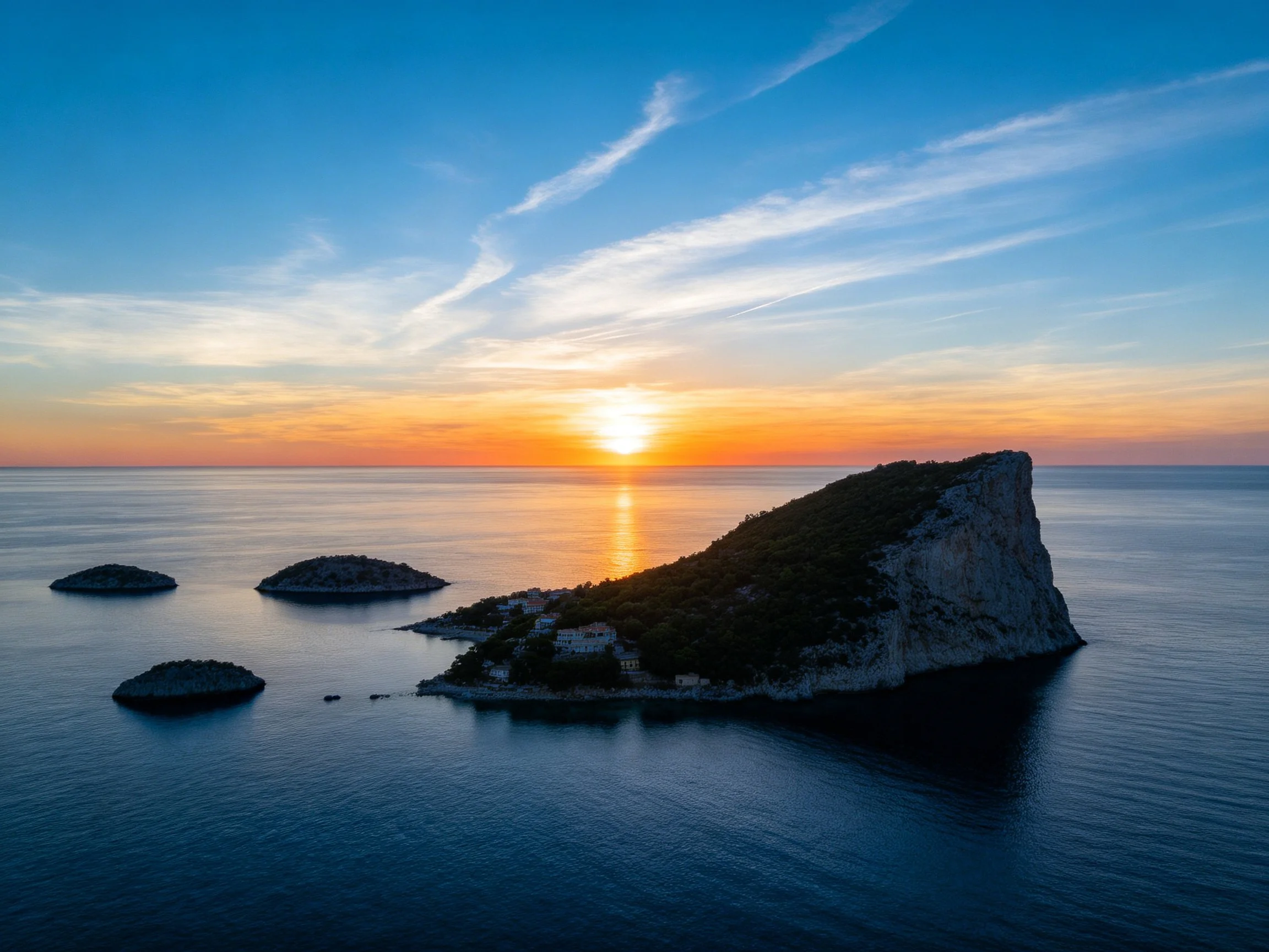 Rocky island and islets under colorful sunset sky