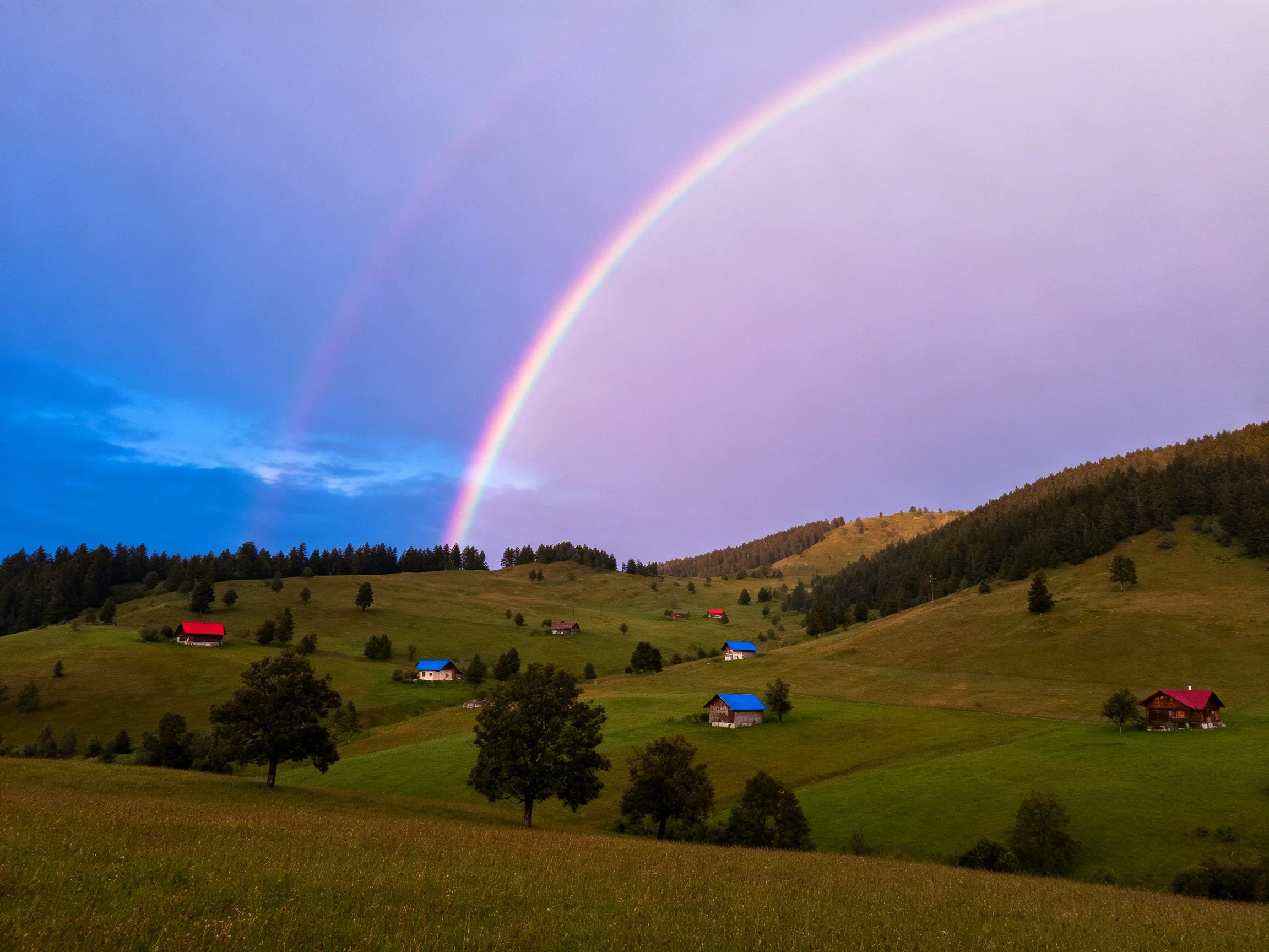 Rolling green hills, colorful cabins, vivid rainbow spans sky