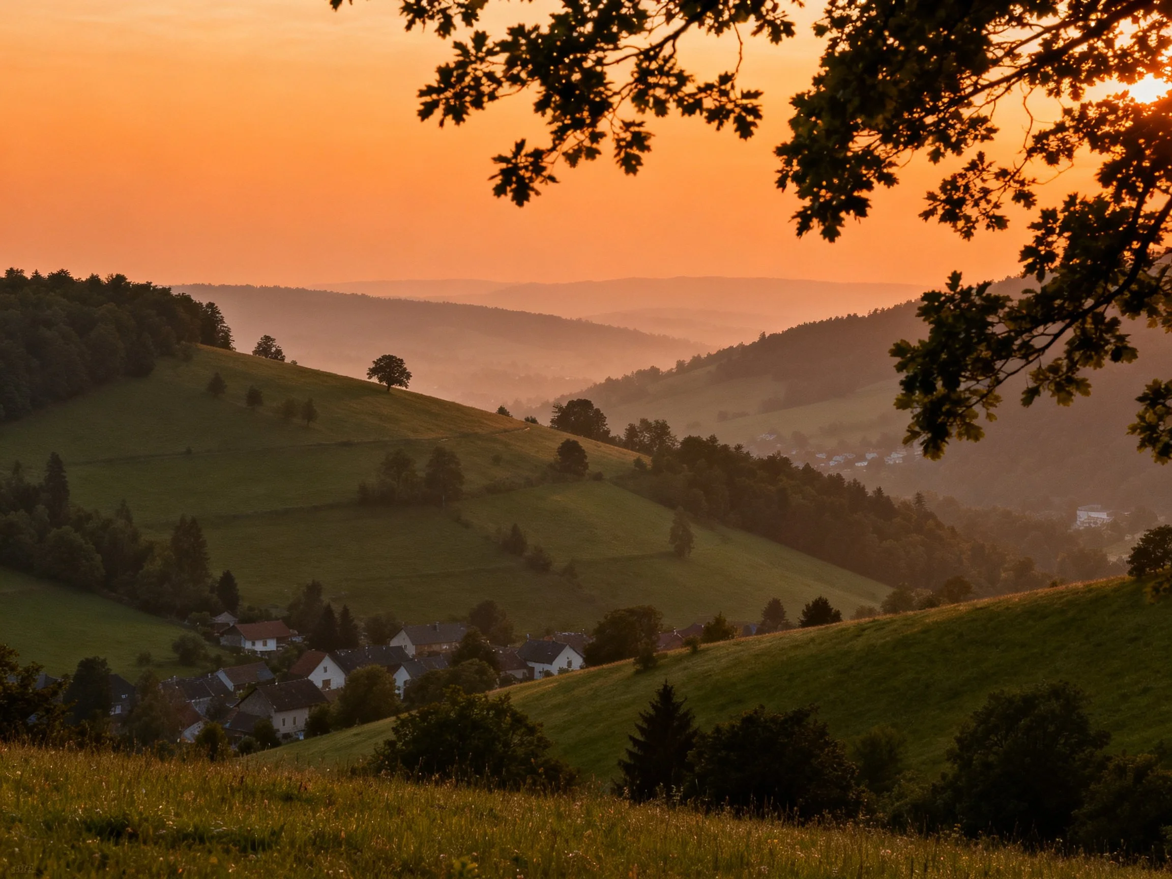 Rolling green hills surround a sunset-lit village landscape