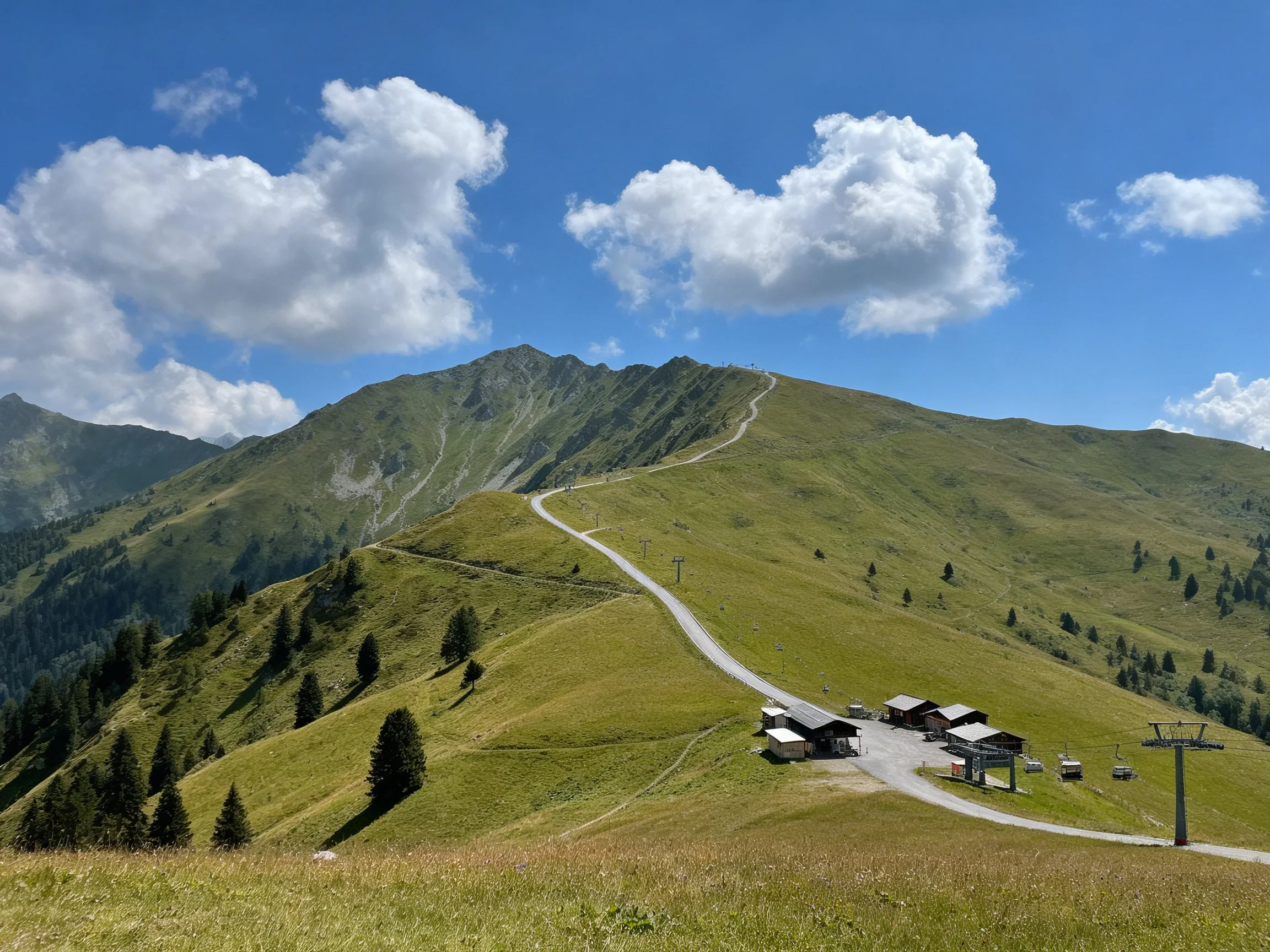 Rolling green mountains, ski facilities, and clear blue sky