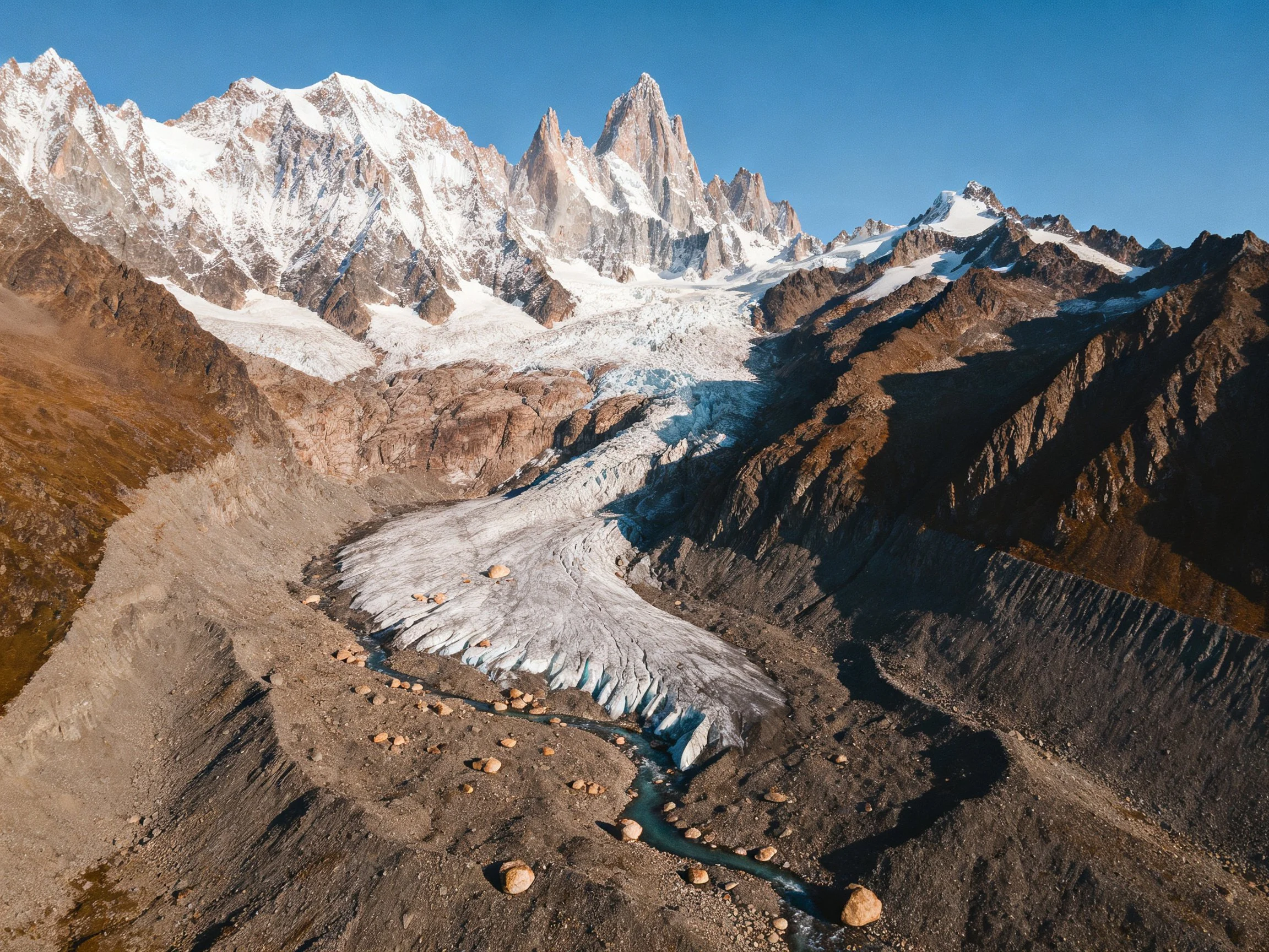 Rugged mountains with snow-capped peaks and sprawling glacier