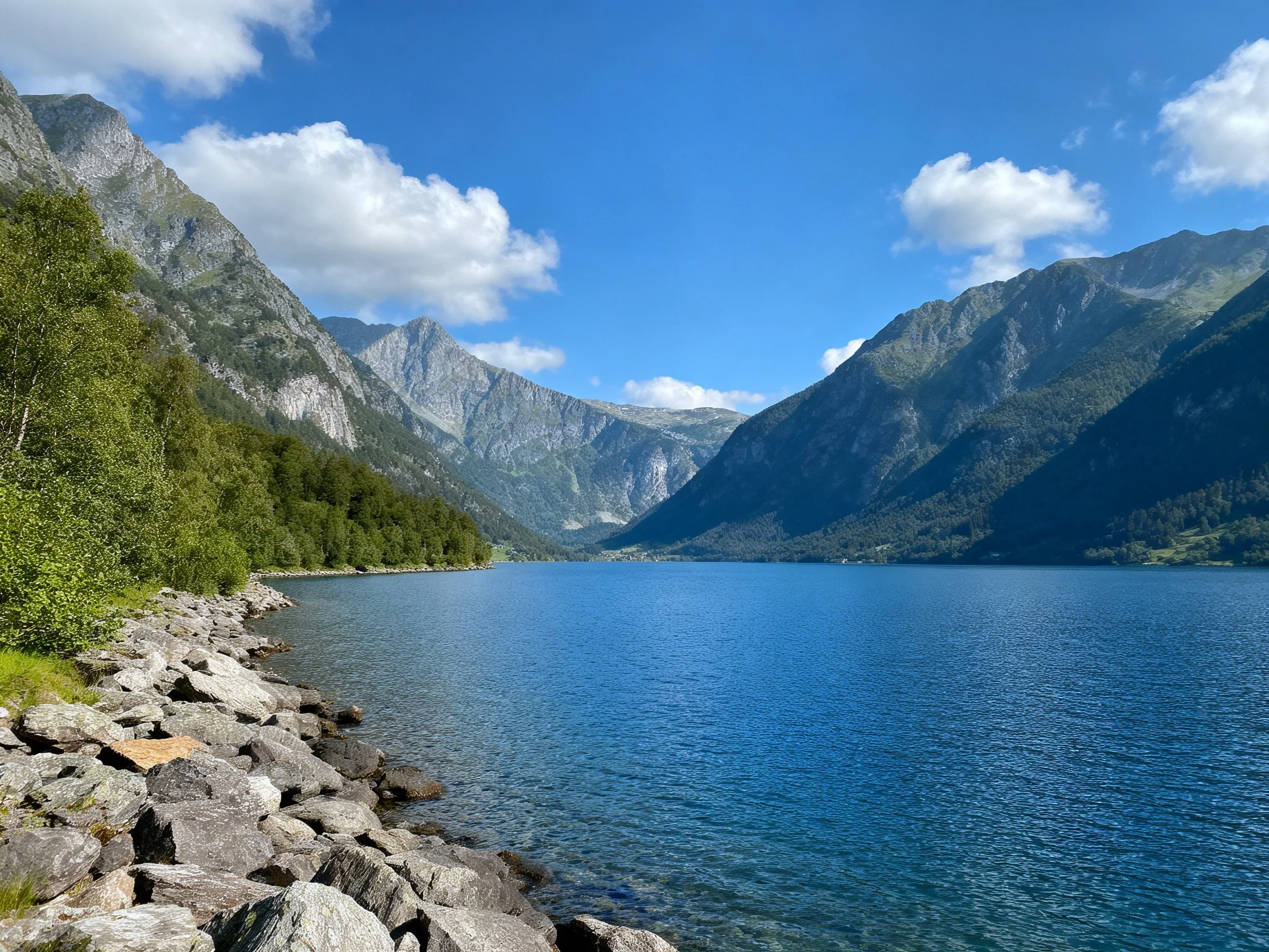 Serene lake bordered by rocky shores and towering mountains