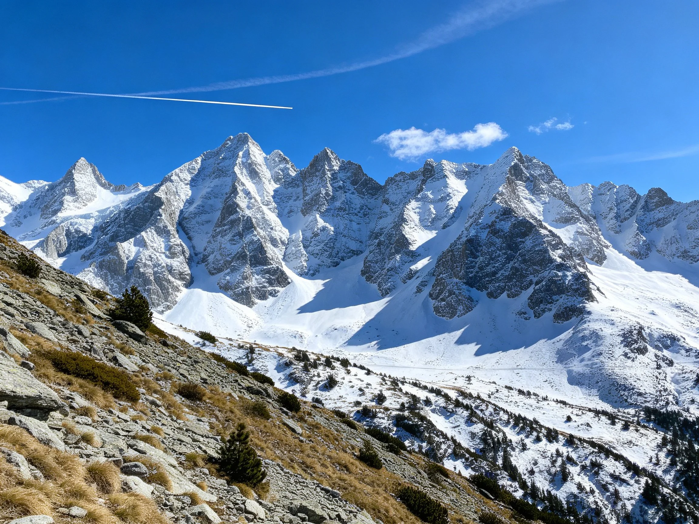 Snow - Capped Alpine Peaks with Rocky Foreground