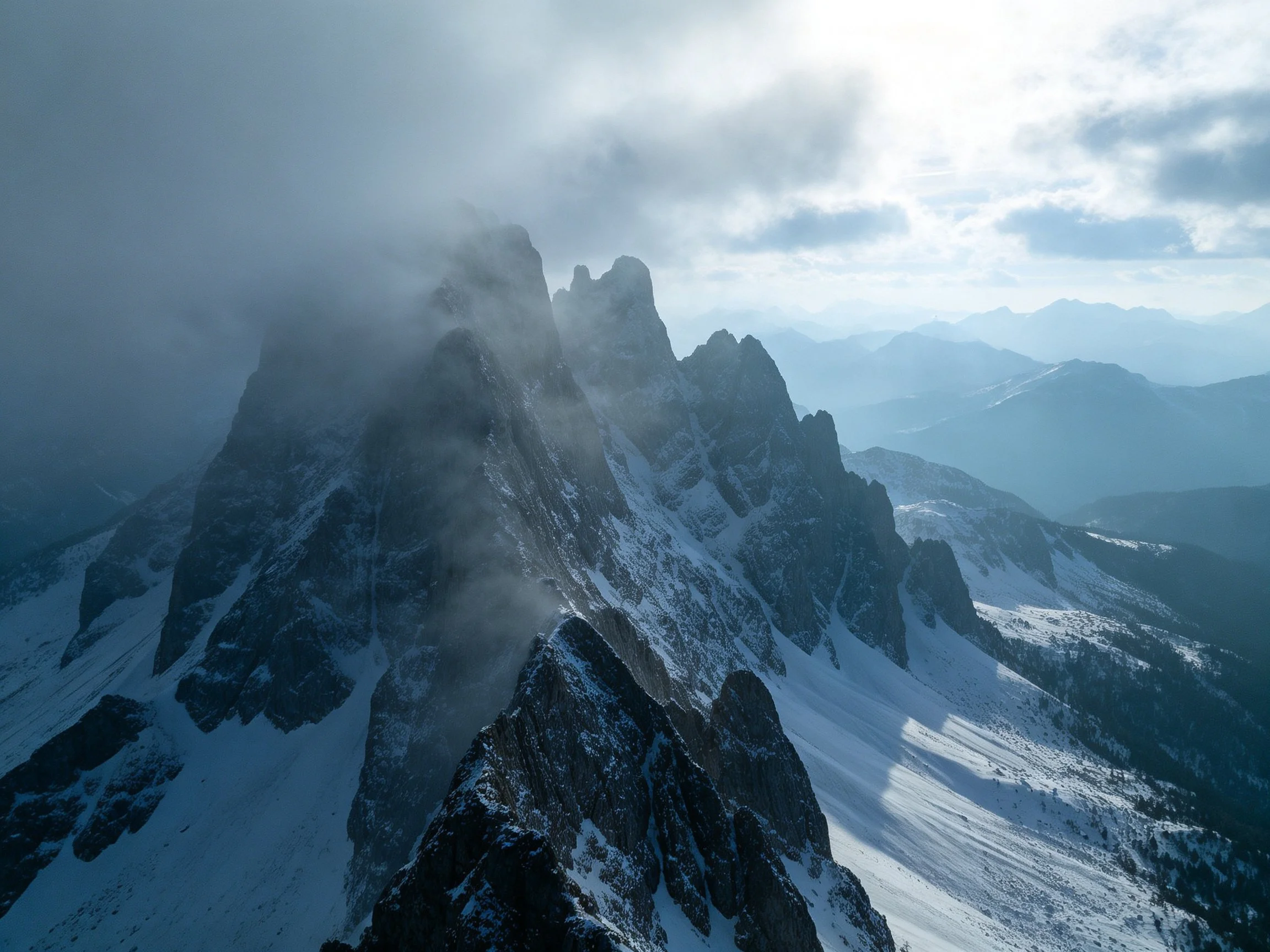 Snow-Capped Jagged Peaks With Misty Mountain Backdrops