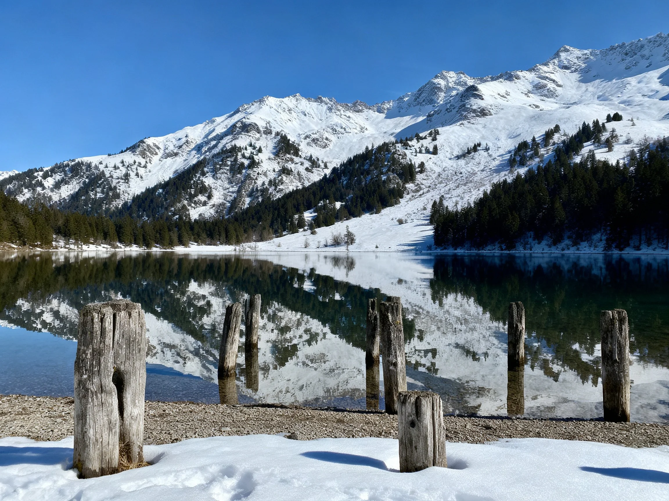 Snow-Capped Peaks Reflecting in Crystal Clear Lake Waters