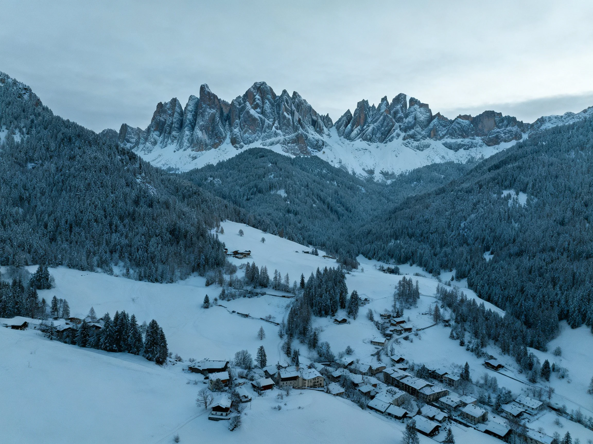 Snow-Covered Valley with Jagged Alpine Peaks