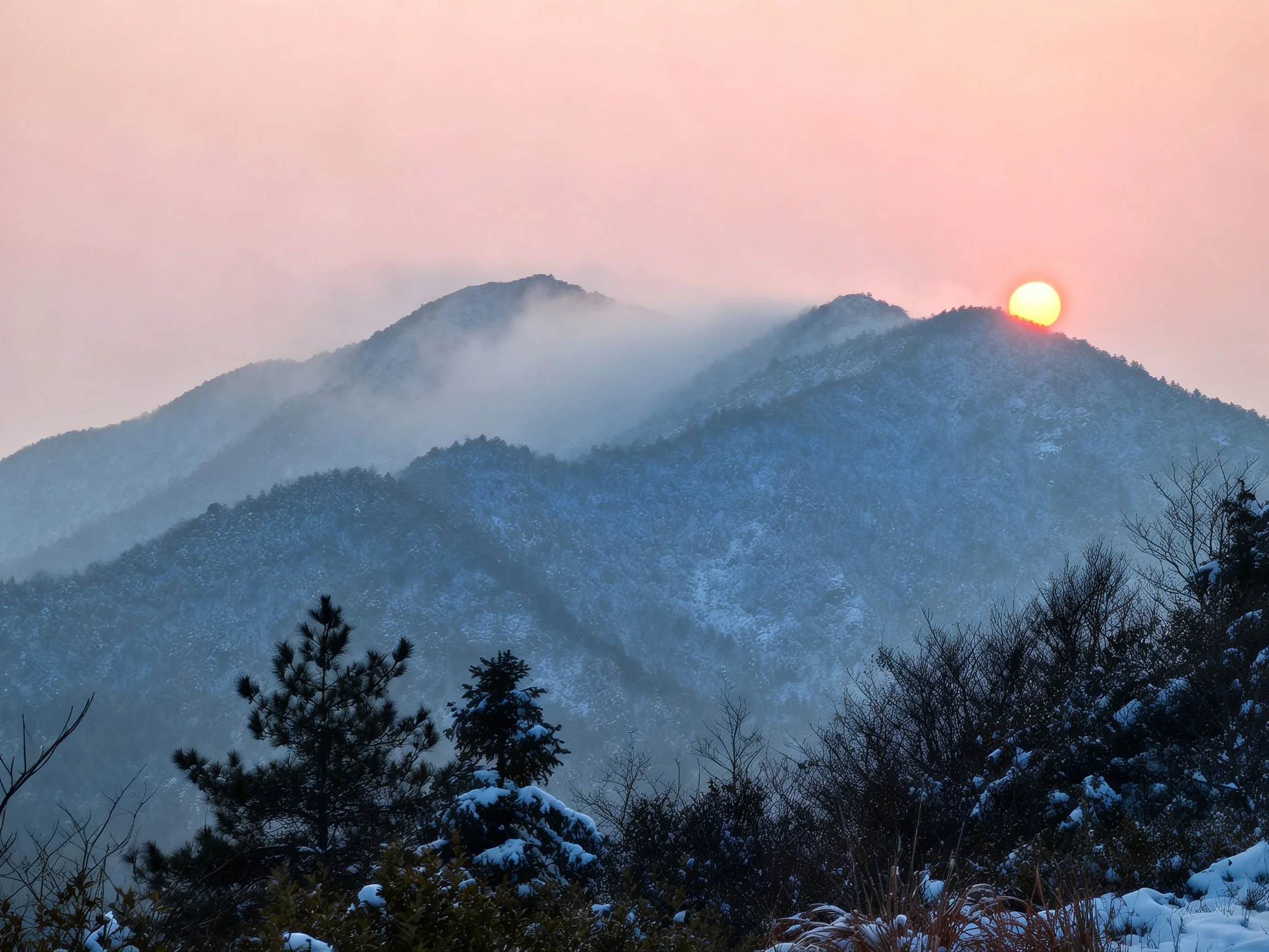 Snow-capped mountain range at sunrise
