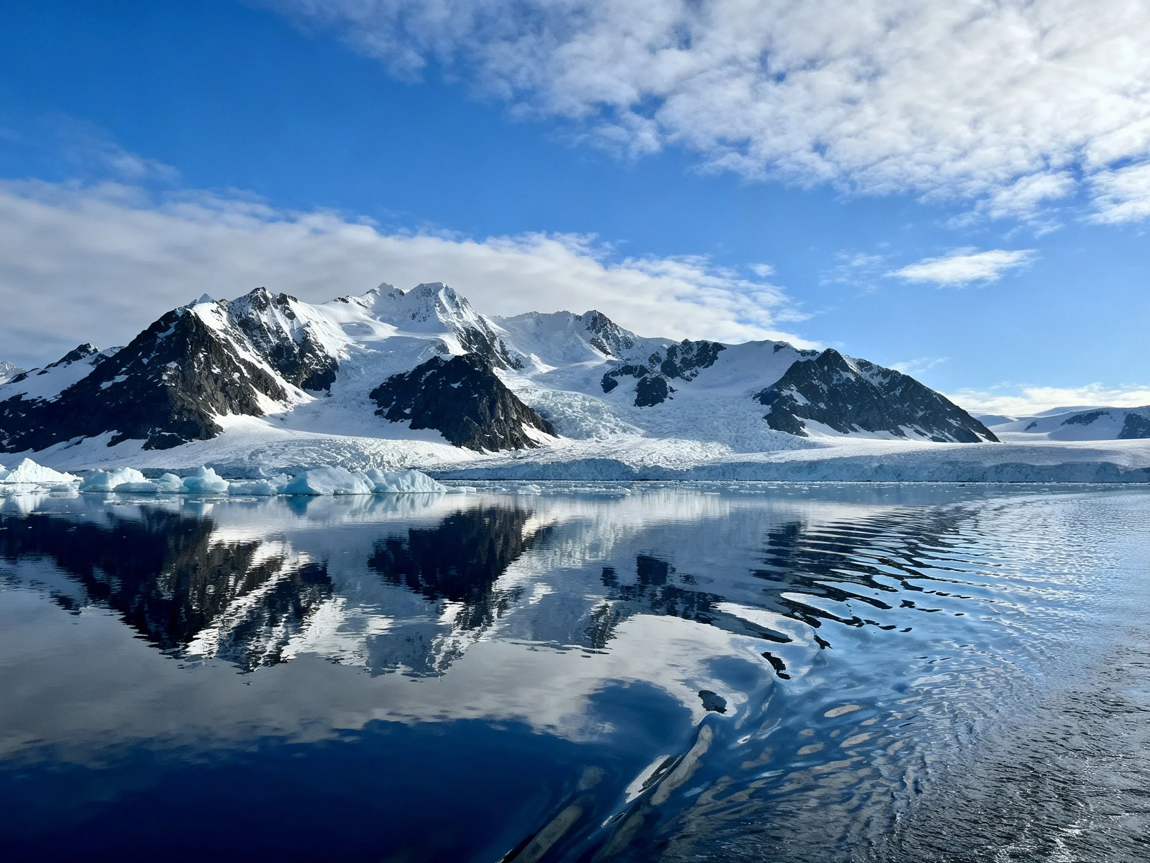 Snow - capped mountains and glaciers reflected in tranquil Antarctic waters