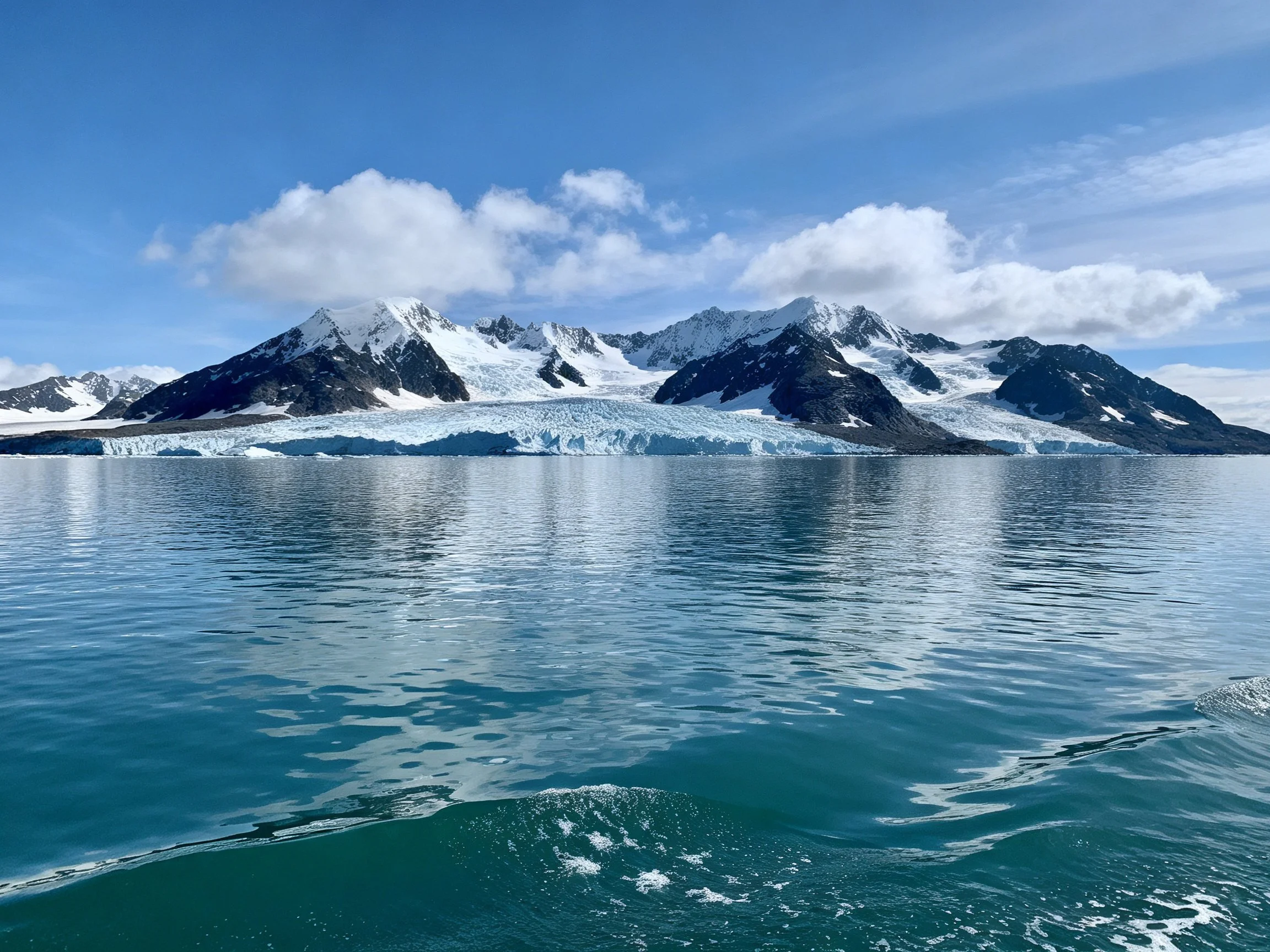 Snow - capped mountains, glacier, and turquoise waters create a serene landscape
