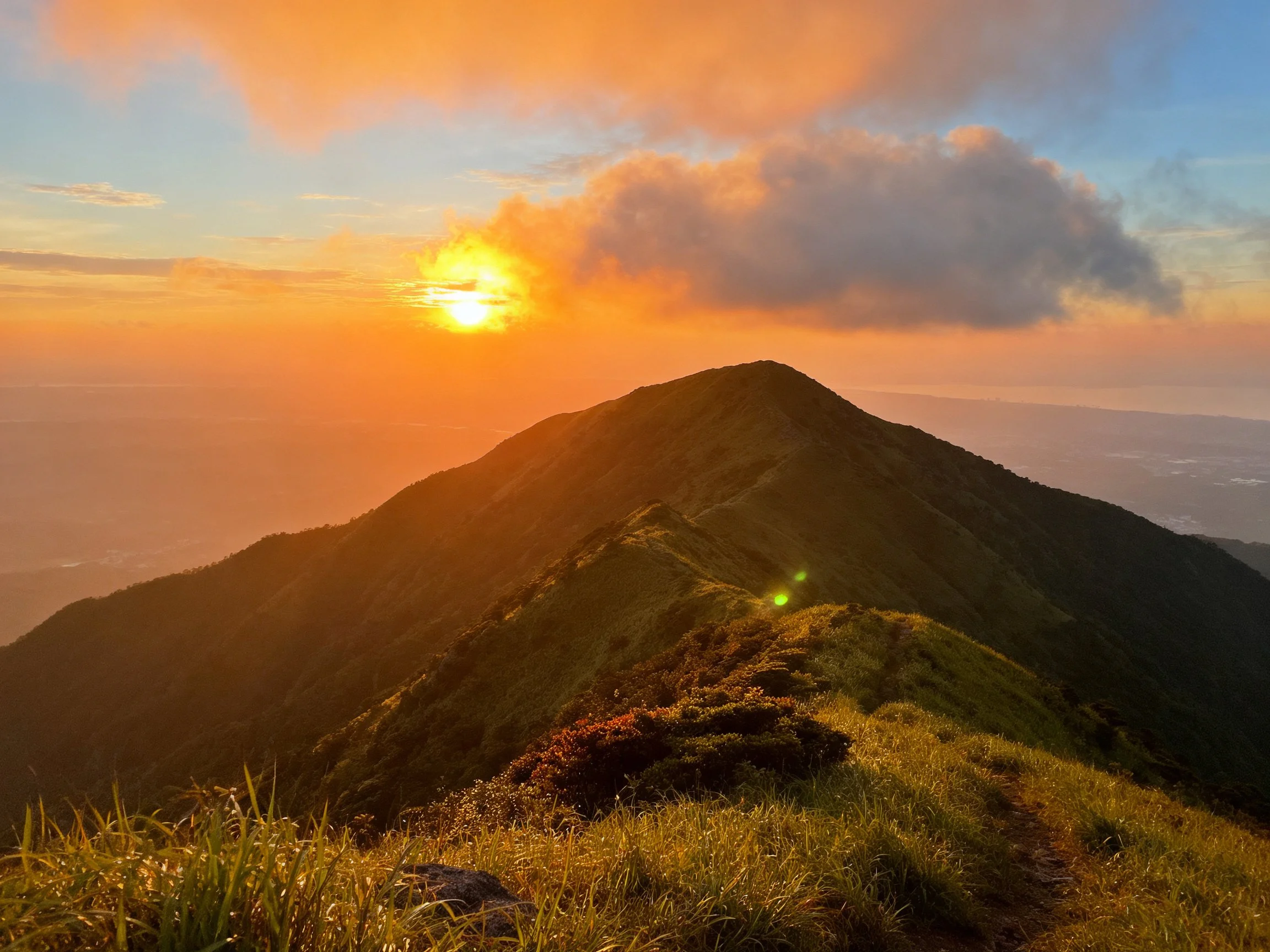 Sunset Over Lush Green Mountain Ridge with Golden Light