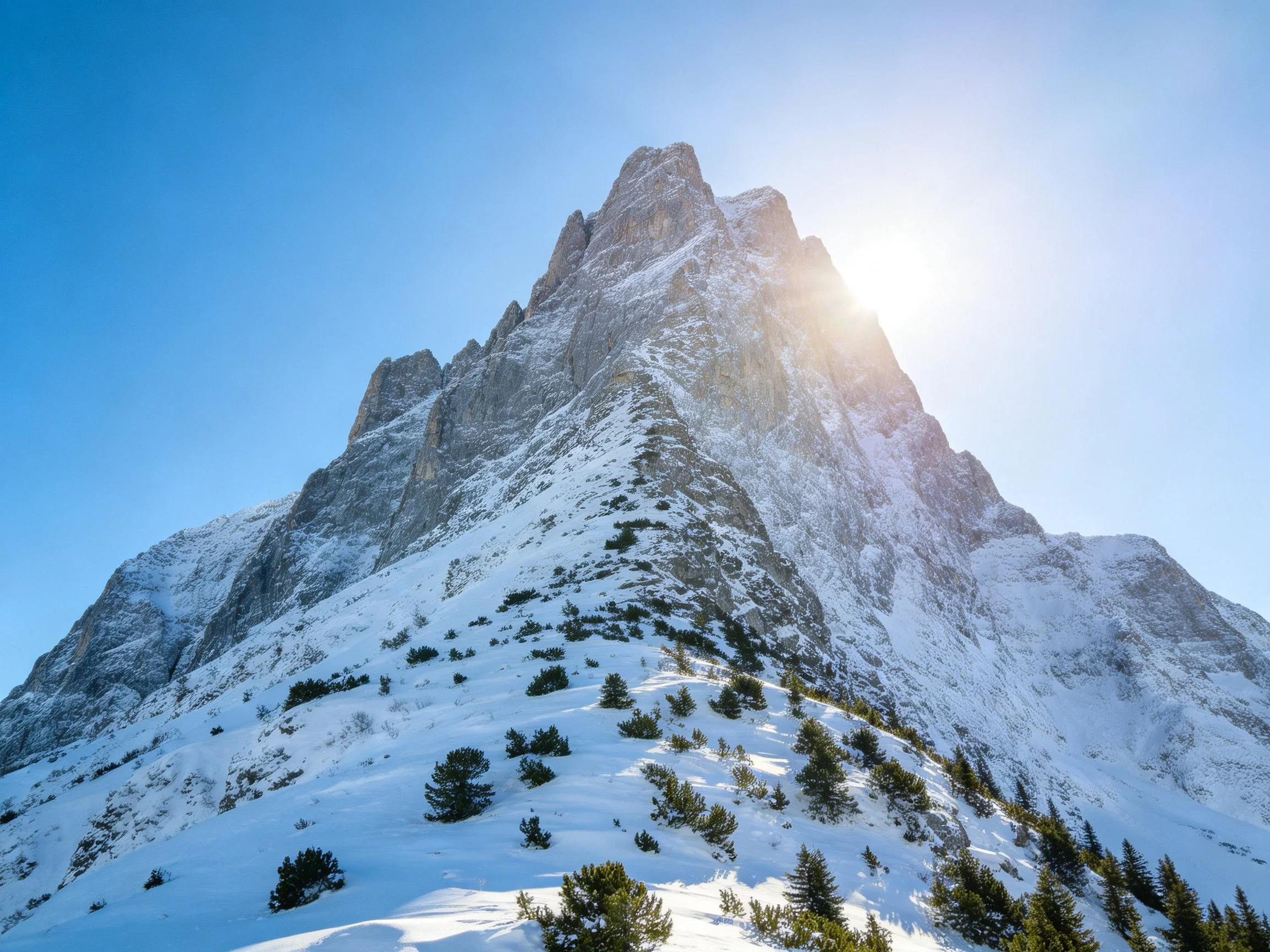 Tall Snow-Capped Mountain Peak with Sunlight