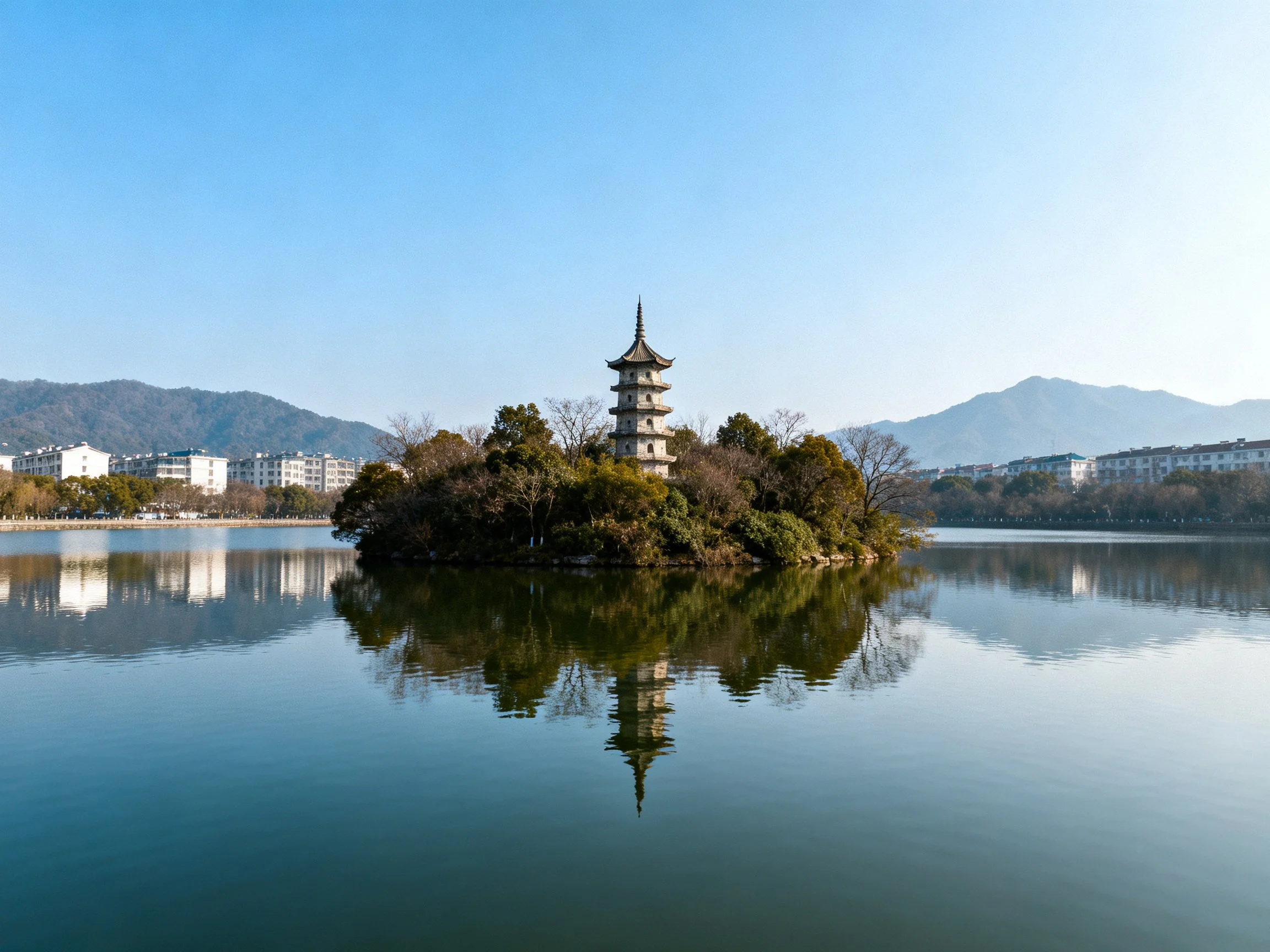Traditional pagoda tower on small island in calm lake