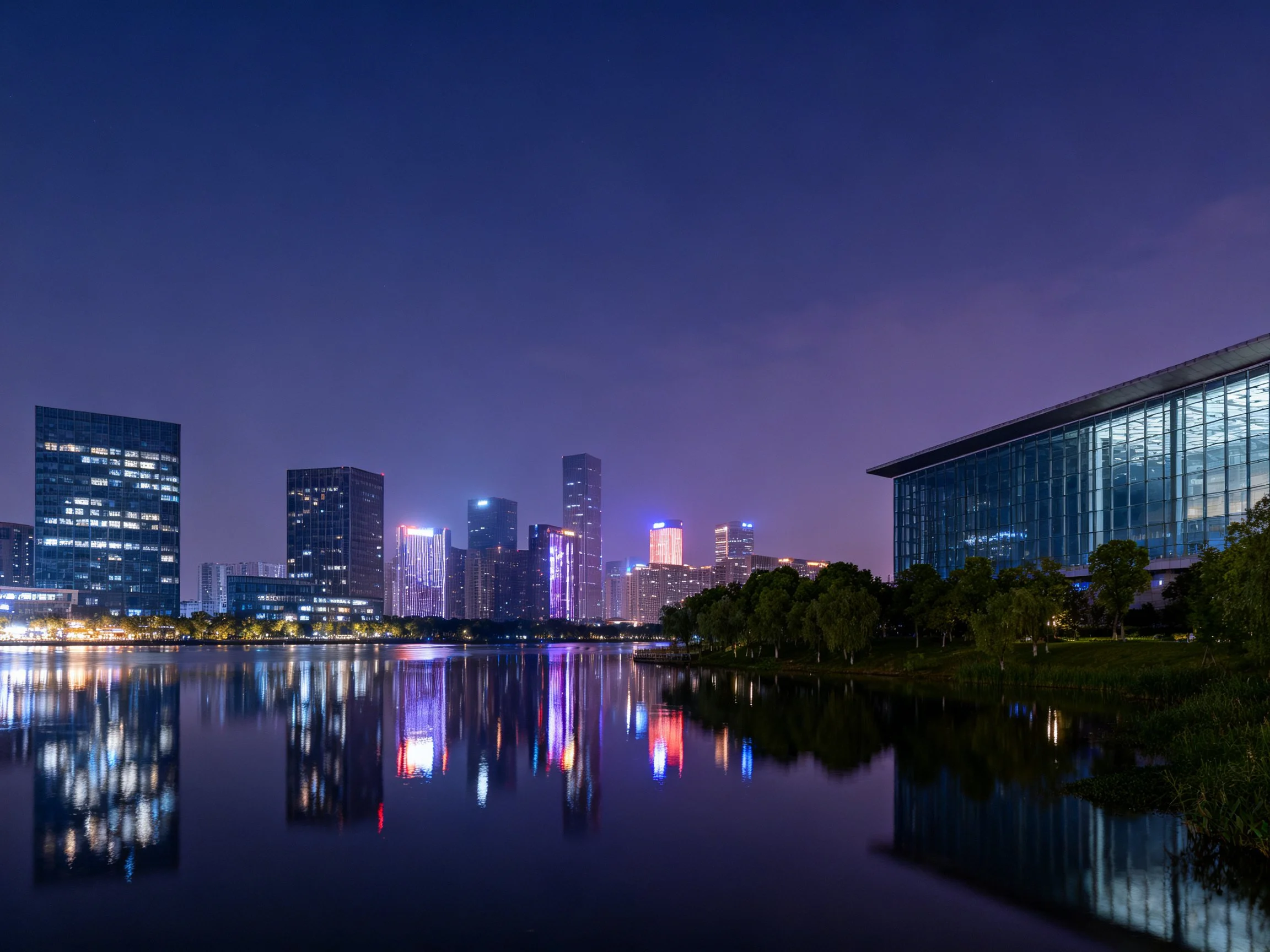 Twilight skyscraper reflections in calm water near modern glass building