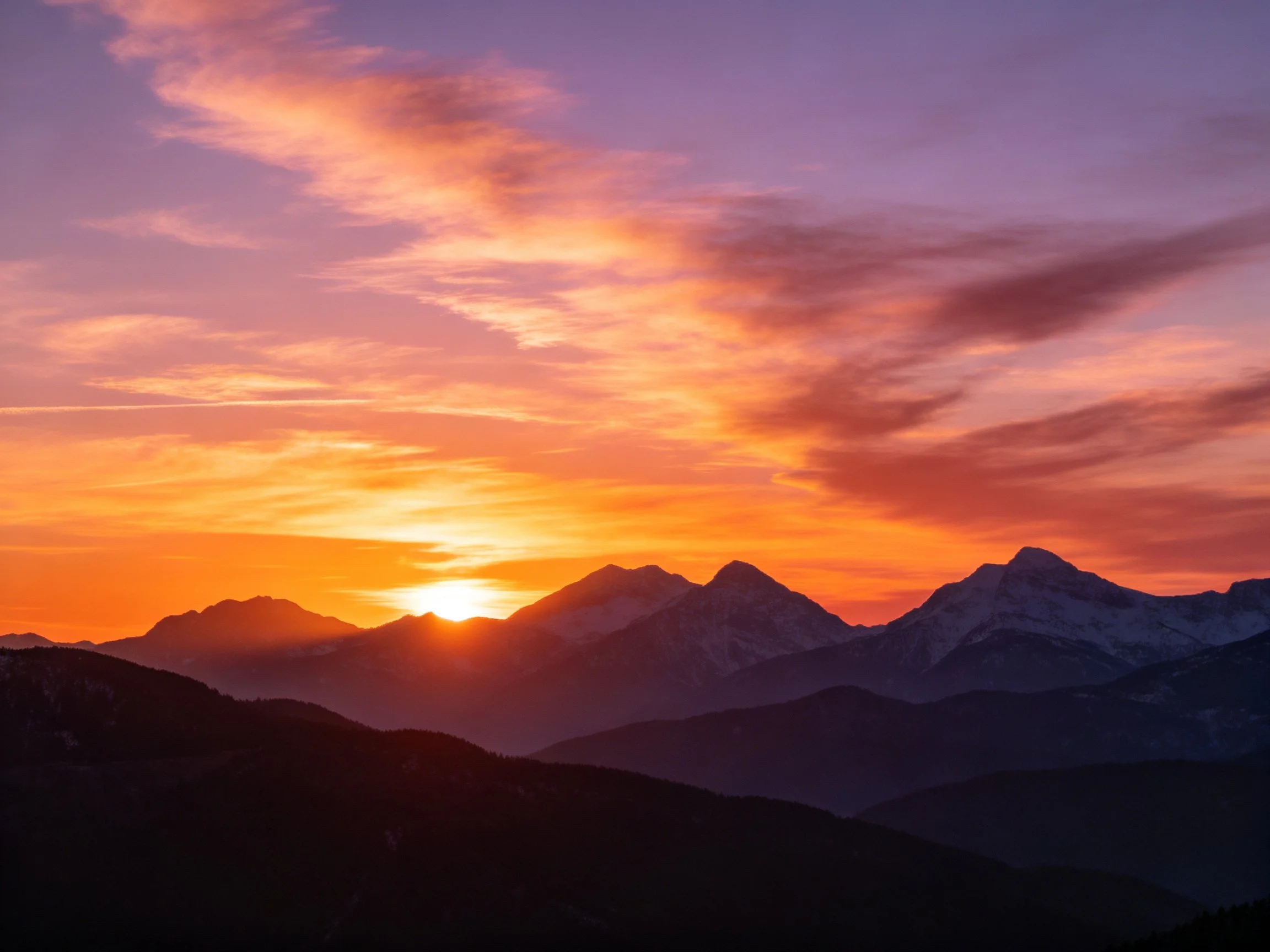 Vibrant Sunset Colors Over Mountain Silhouettes