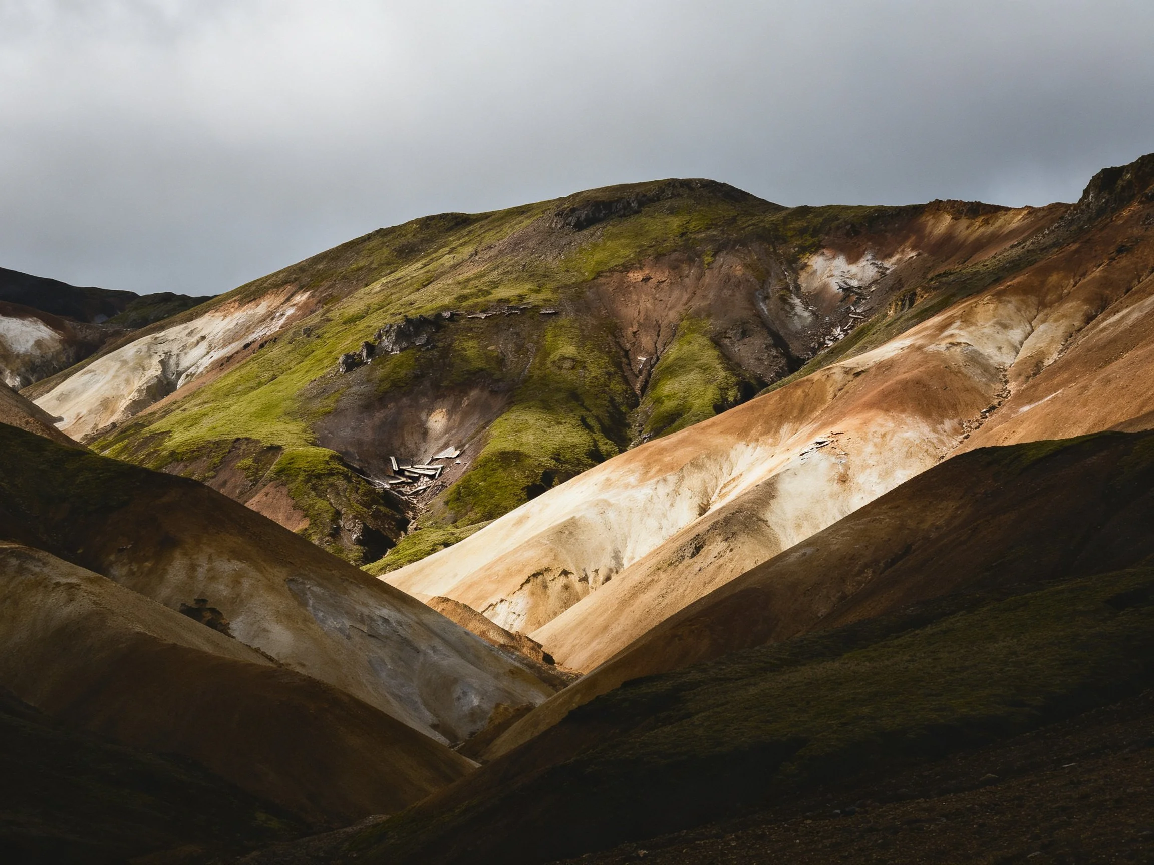 Vibrant multicolored mountain slopes with lush green patches