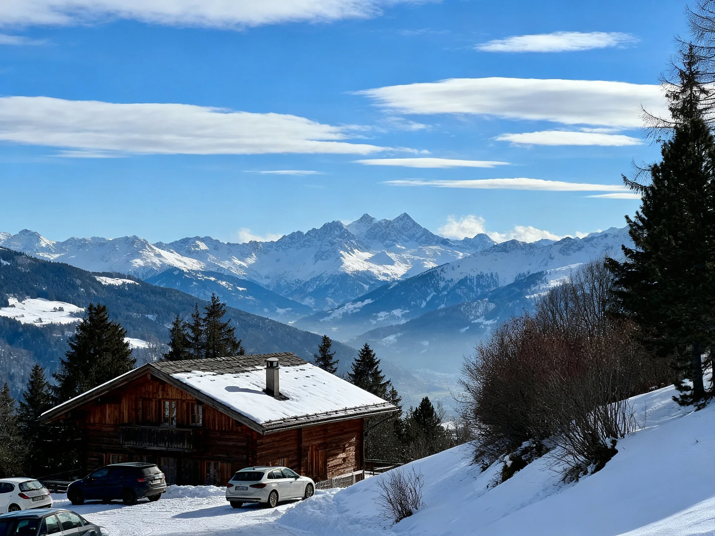 Wooden Cabin Near Snow-Covered Slopes With Majestic Mountain Peaks